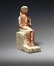 Brooklyn Museum: Statuette of Seated Man Clasping a Lotus Blossom
