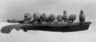 Carving of nine walruses on an ice floe