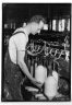 [Untitled]  (Man Lifting Yarn Cone)