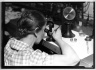 [Untitled] (Woman with Loupe and Tweezers)