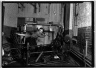 [Untitled] (Two Men Dismantling Metal Frame)