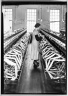 [Untitled]  (Woman between Rows of Skein Wheels)