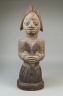 Figure of a Devotee of Shango Holding an Oshe Shango