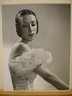 [Untitled]  (Brunette Woman Looking Down with Arms Stretched Toward Bottom Right Hair over Ears)