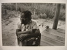 [Untitled] (Close-up of Maude Callen on Porch Holding Flower)