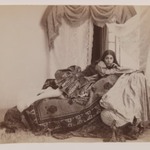 Studio Shot of a Reclining Lady Reading a Book