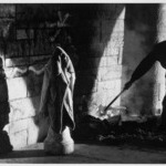 Homeless Man Stoking His Fire, Riverside Park, NYC
