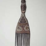 Comb Surmounted by a Head