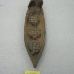 Seated Figurine in Canoe with Three Turtles