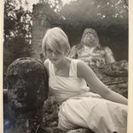Swedish Model (Blonde Woman in White Dress Leaning Against Statue of a Head)